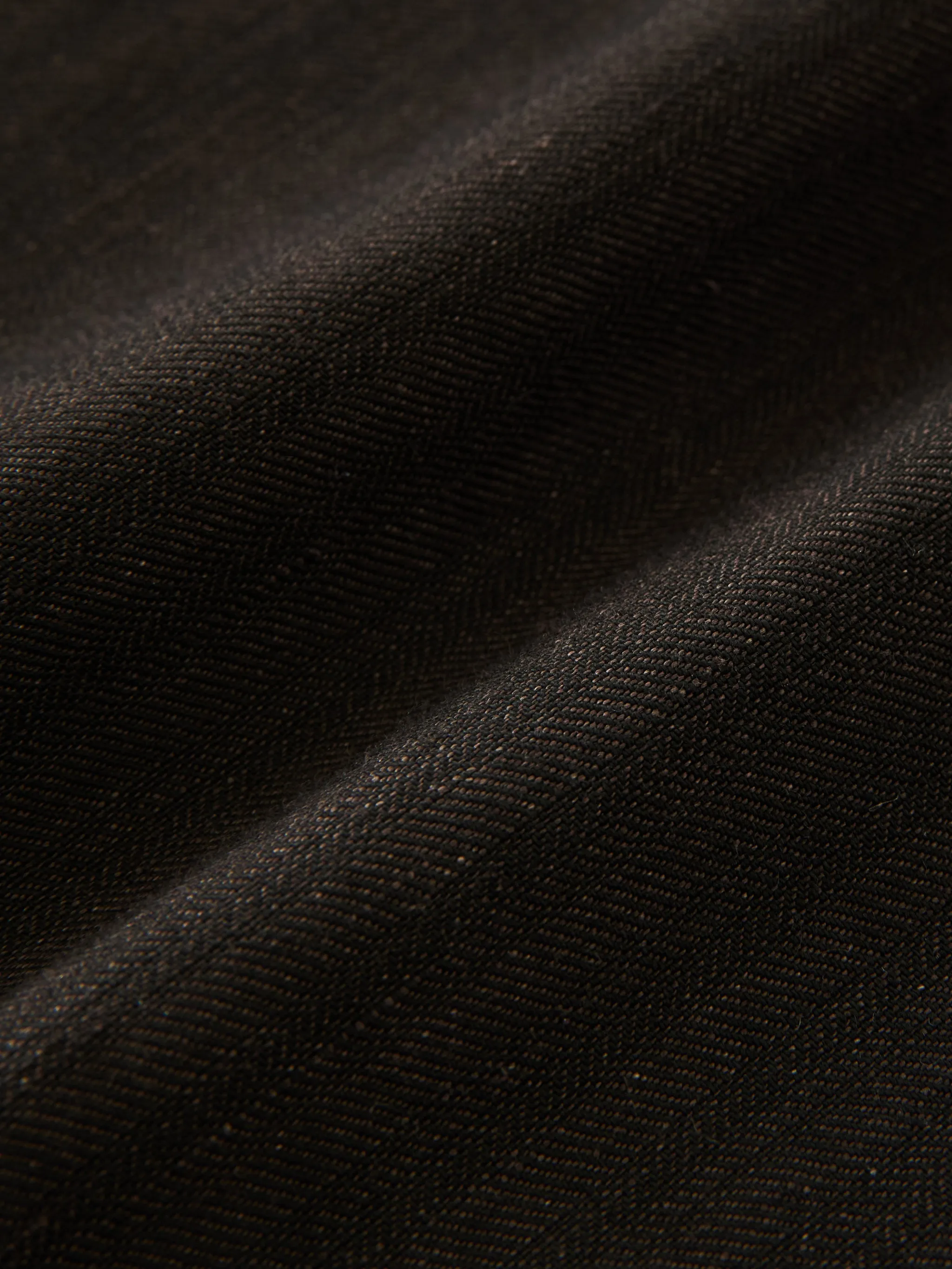 Close up of brown pants, showing texture of the cotton fabric