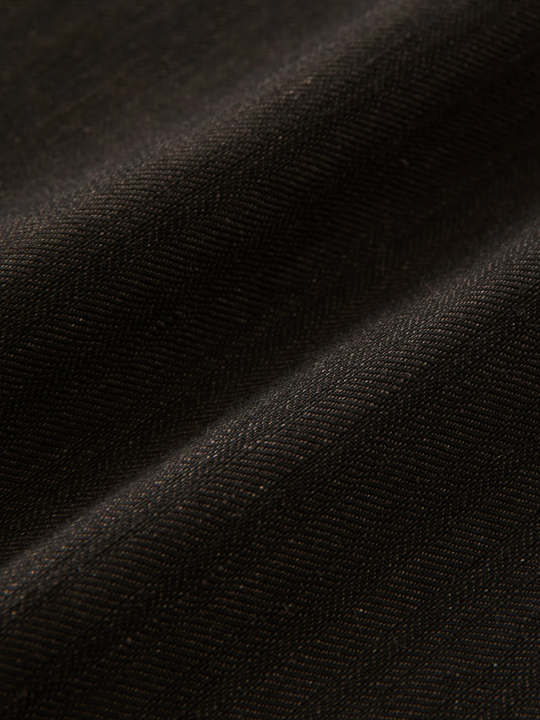 Close up of brown pants, showing texture of the cotton fabric
