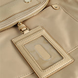 Close up of tan bags, showing texture of the nylon fabric