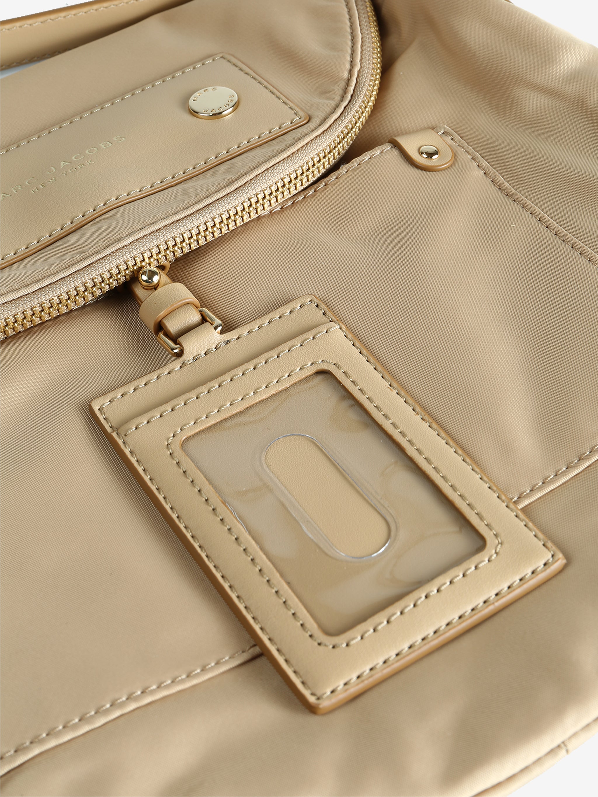 Close up of tan bags, showing texture of the nylon fabric