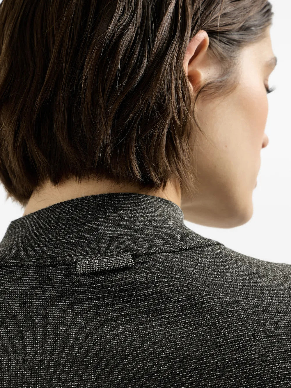Grey knitwear worn by a person, showing the knitwear fit