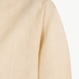 Close up of tan top,showing texture of the cotton fabric.