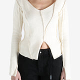 White sweater worn by a person, showing the sweater's fit