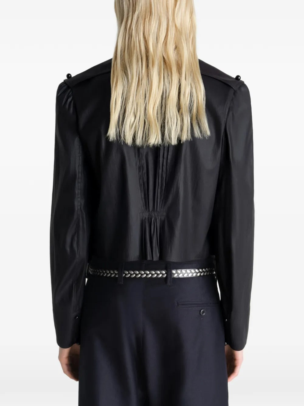 Black tops worn by a person, showing the tops fit