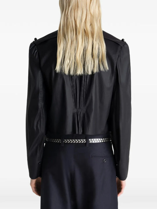 Black tops worn by a person, showing the tops fit