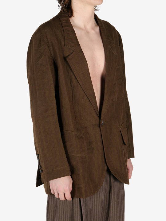 Brown jacket worn by a person, showing the jacket's fit