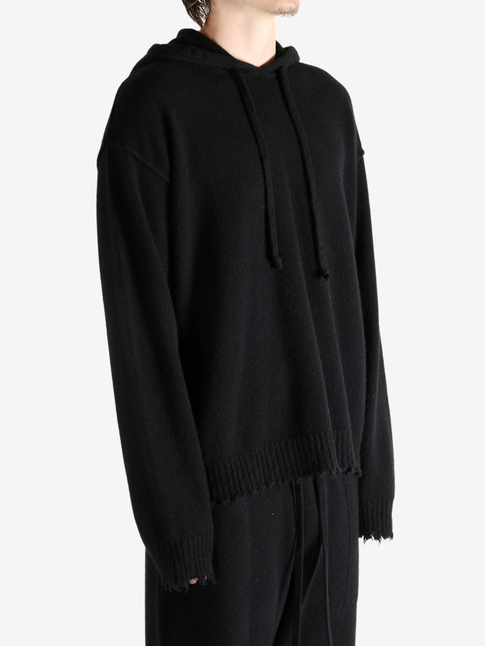 Black top worn by a person, showing the top's fit