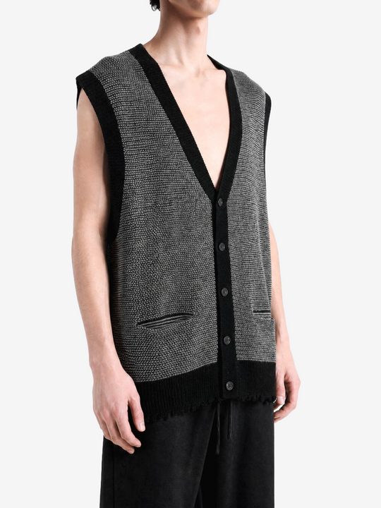 Grey knitwear worn by a person, showing the knitwear fit