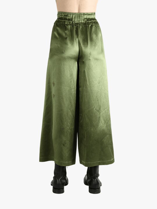 Green pants worn by a person, showing the pants fit