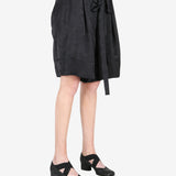 Black pant worn by a person, showing the shirt fit