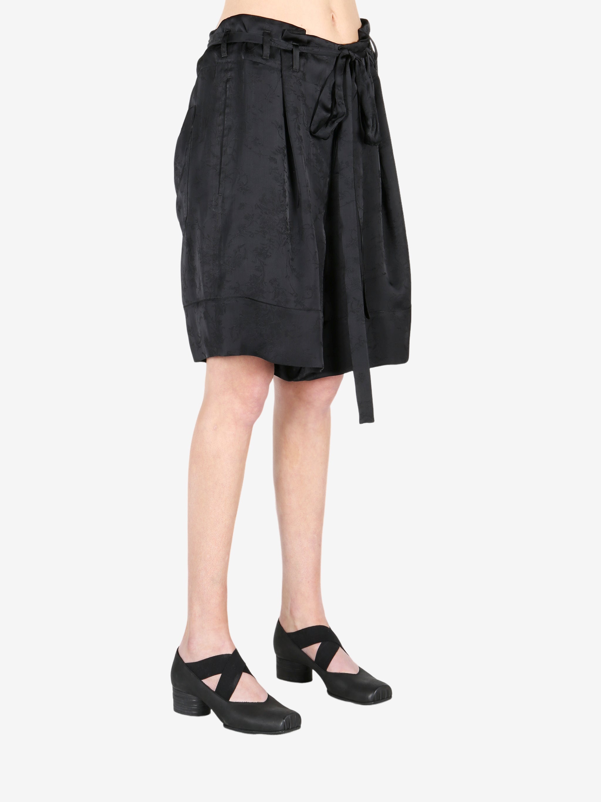 Black pant worn by a person, showing the shirt fit