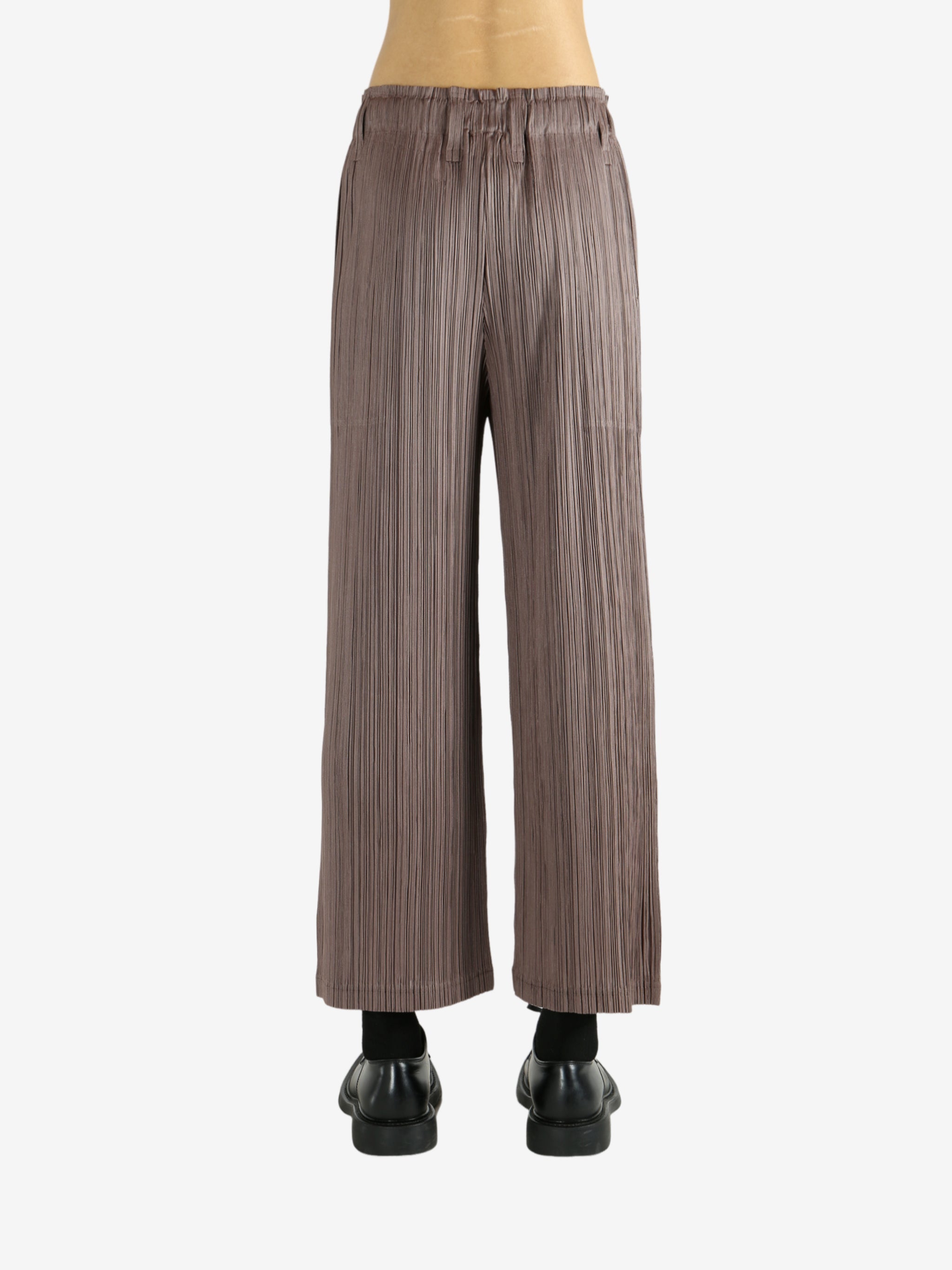 Brown pants worn by a person, showing the pants' fit