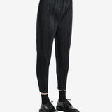 Black pants worn by a person, showing the pants' fit