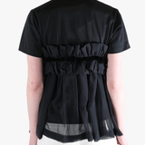 Black t-shirts worn by a person, showing the t-shirts fit