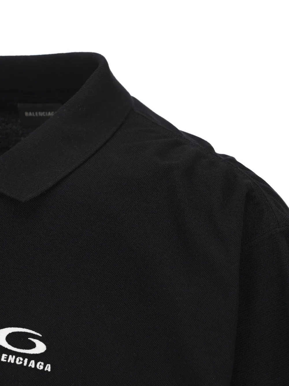 Close up of the black t-shirt, showing texture of the cotton material 