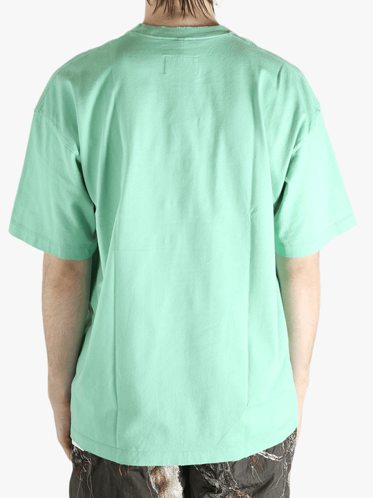 Green t-shirt worn by a person, showing the t-shirt's fit