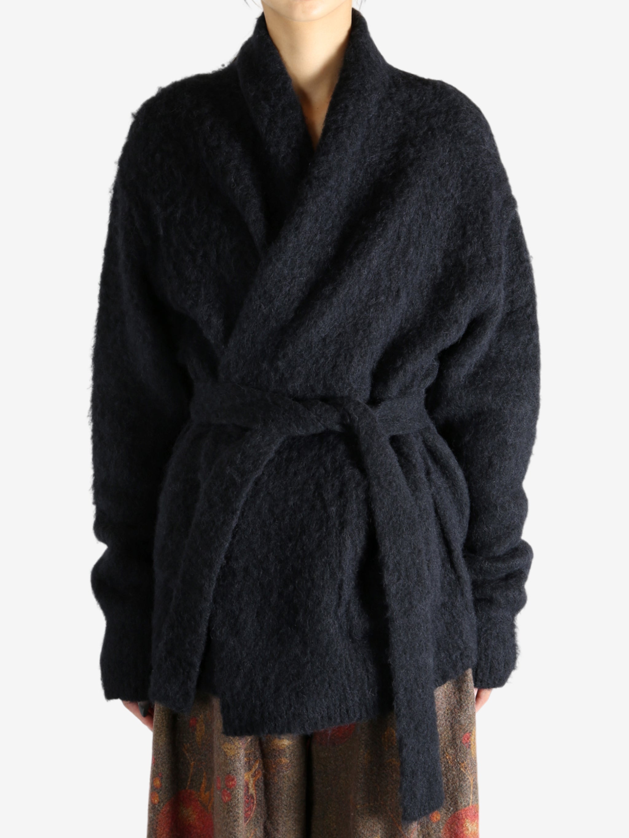 Black cardigan worn by a person, showing the cardigan fit