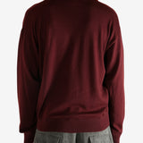 Red sweater worn by a person, showing the sweater's fit