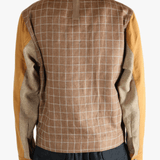 Brown jackets worn by a person, showing the jacket's fit 