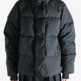 Black coat worn by a person, showing the coat's fit