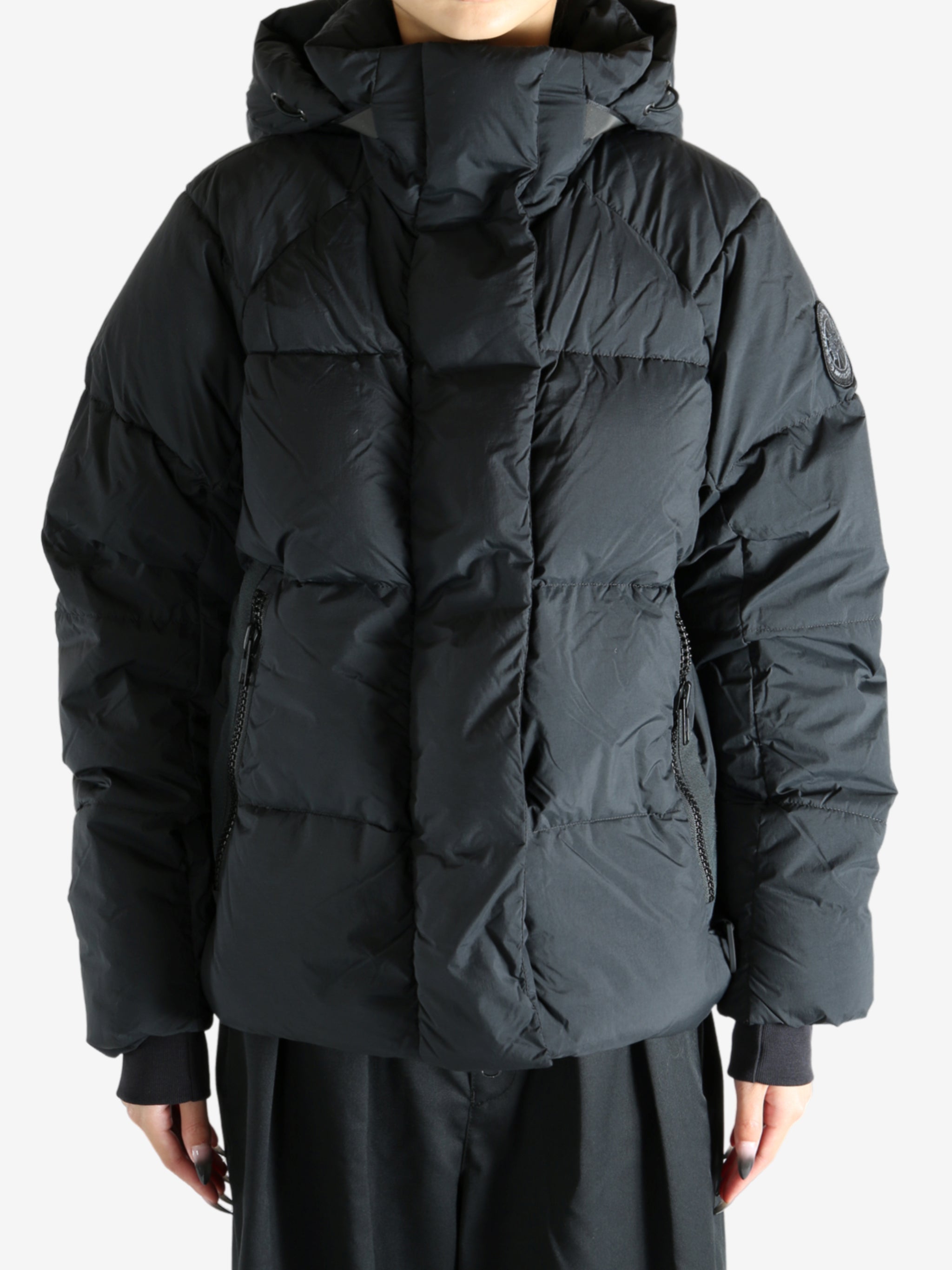 Black coat worn by a person, showing the coat's fit