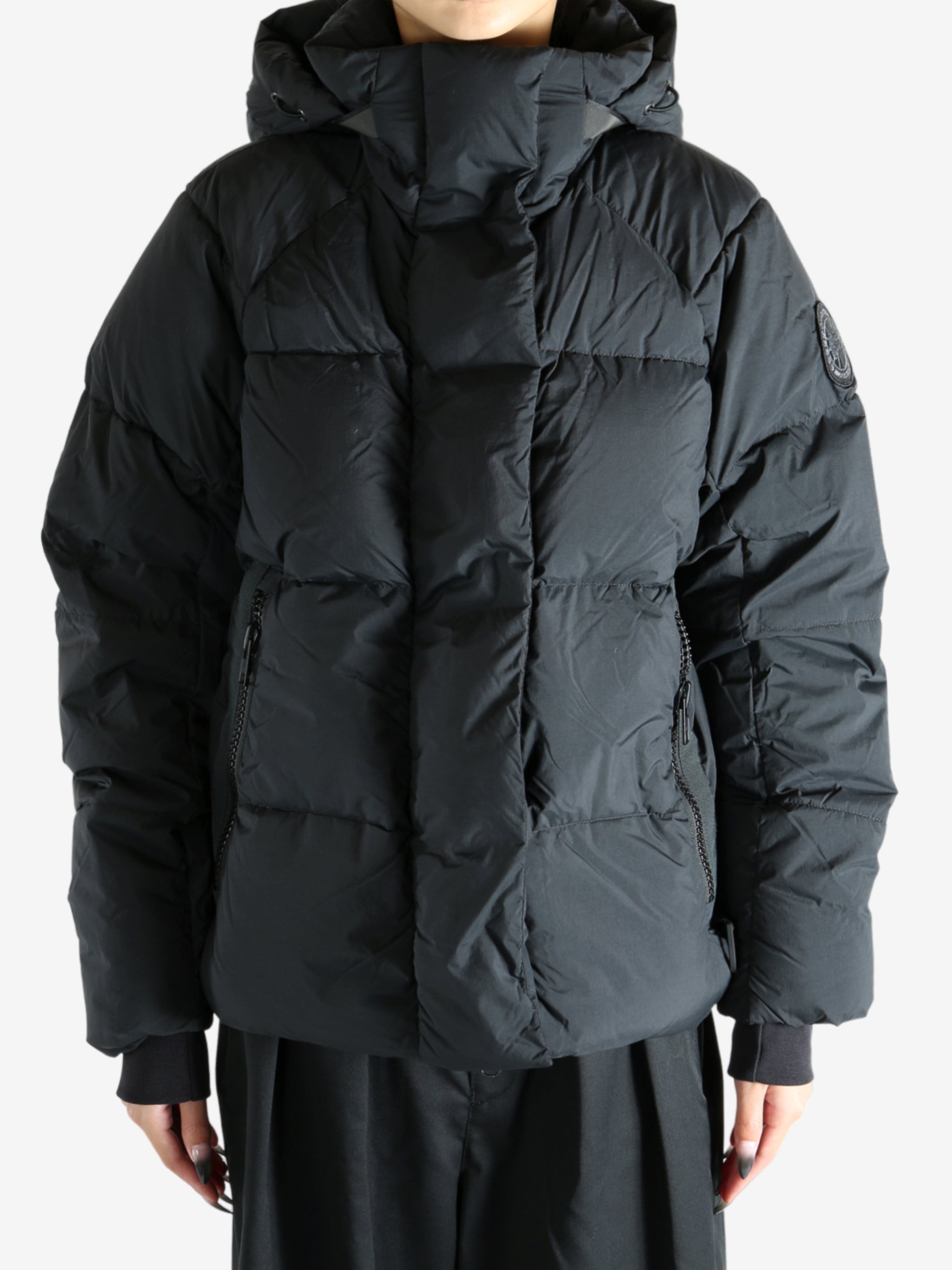 Black coat worn by a person, showing the coat's fit