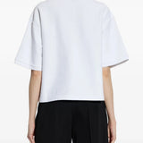 White t-shirt worn by a person, showing the t-shirt's fit