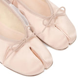 Close up of pink shoes, showing texture of the fabric