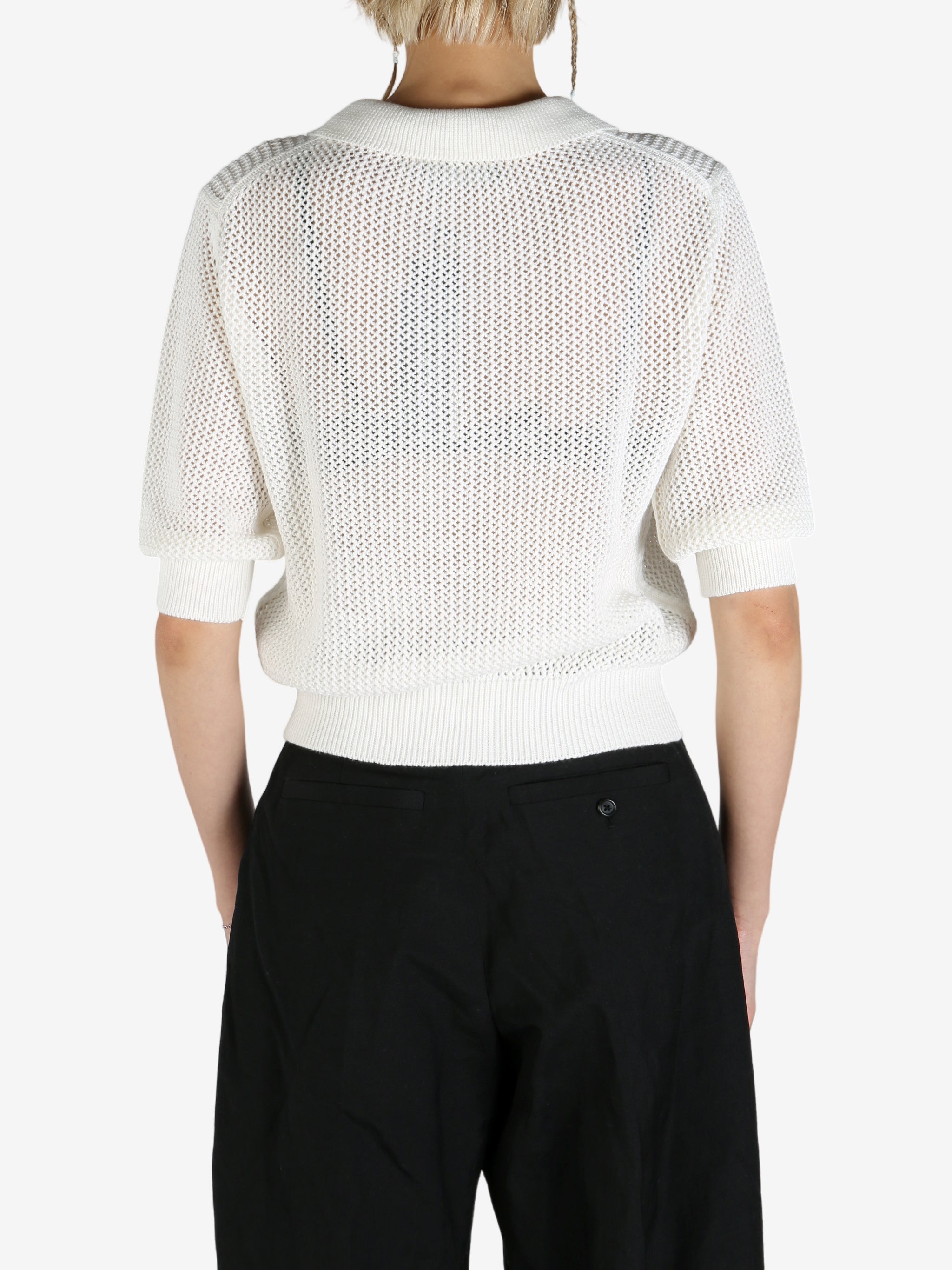 White shirt worn by a person, showing the shirt's fit