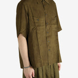 Green shirt worn by a person, showing the shirt's fit