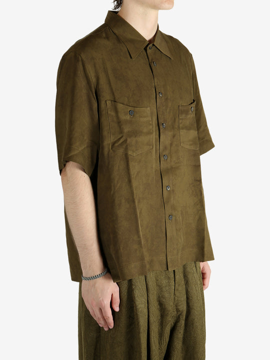 Green shirt worn by a person, showing the shirt's fit