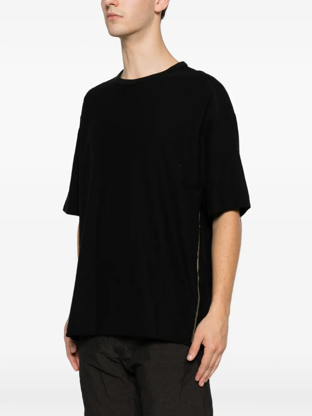 Black top worn by a person, showing the top fit