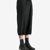 Black pants worn by a person, showing the pants's fit