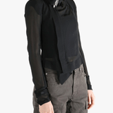 Black long sleeve worn by a person, showing the tight fit.