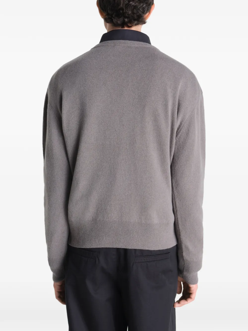 Grey sweater worn by a person, showing the sweater fit