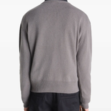 Grey sweater worn by a person, showing the sweater fit