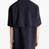Black shirt worn by a person, showing the shirt's fit