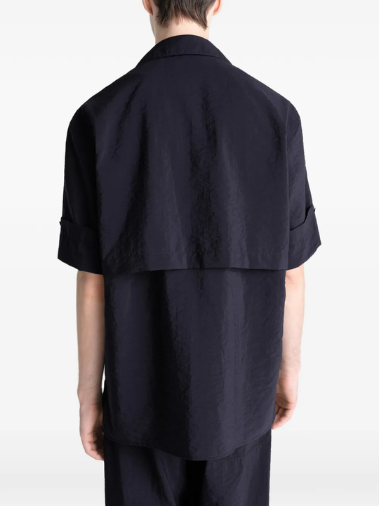 Black shirt worn by a person, showing the shirt's fit