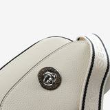 Close up of tan bag, showing texture of the cow leather fabric