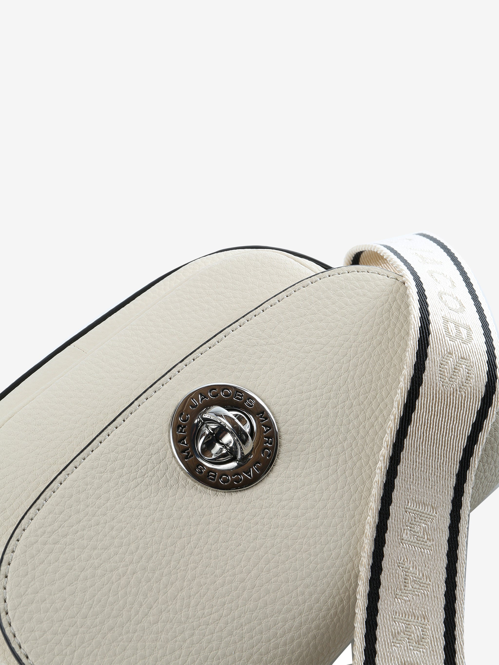 Close up of tan bag, showing texture of the cow leather fabric