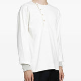 White top worn by a person, showing the top fit