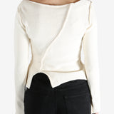 White sweater worn by a person, showing the sweater's fit