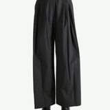 Black pants worn by a person, showing the pants fit