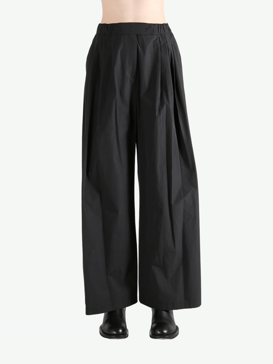Black pants worn by a person, showing the pants fit