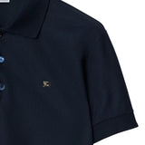Close-up of navy polo, showing texture of cotton fabric