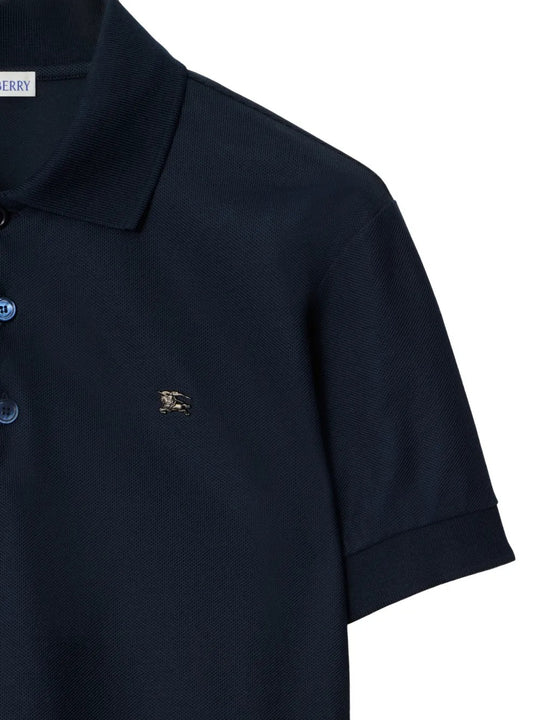 Close-up of navy polo, showing texture of cotton fabric