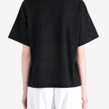 Black t-shirt worn by a person, showing the t-shirt fit