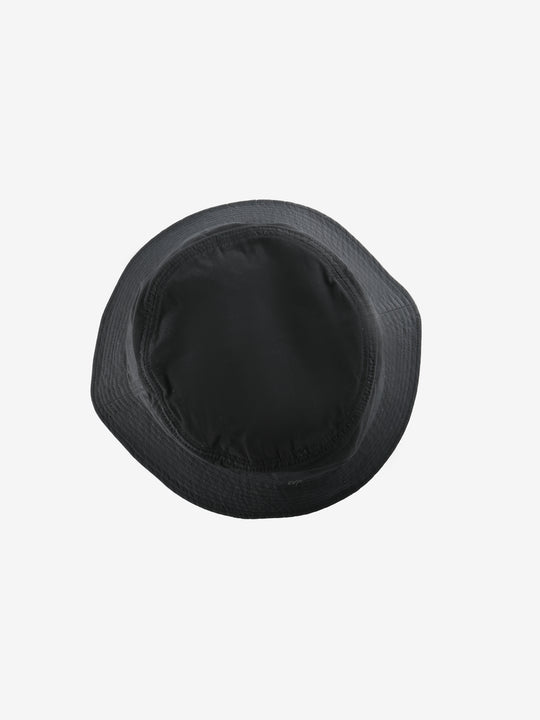 Close up of black hats, showing texture of the polyester and nylon fabric