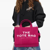 Pink bag, carried by a person, showing the bag's size