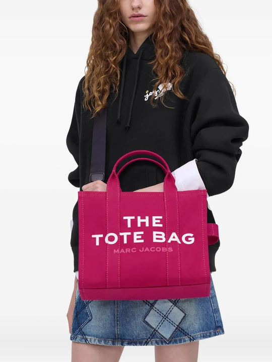 Pink bag, carried by a person, showing the bag's size